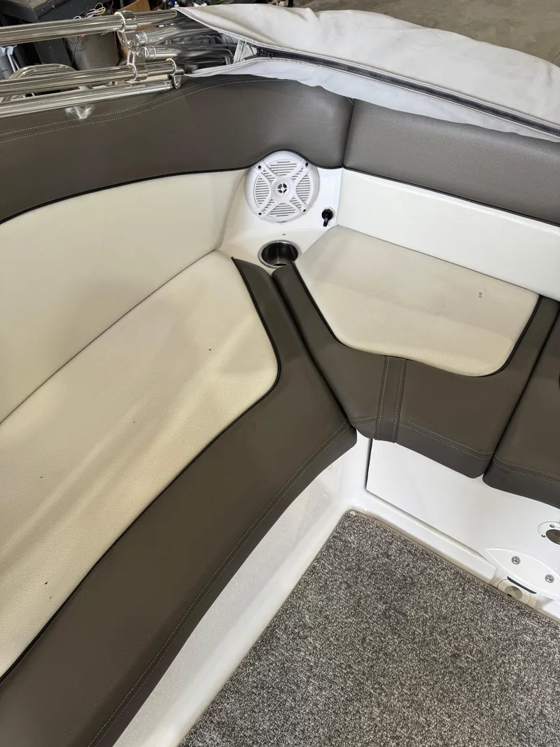 Slide: The Image of 2011 Yamaha Boats 242 Limited interior seating with speaker and cup holder. - 10