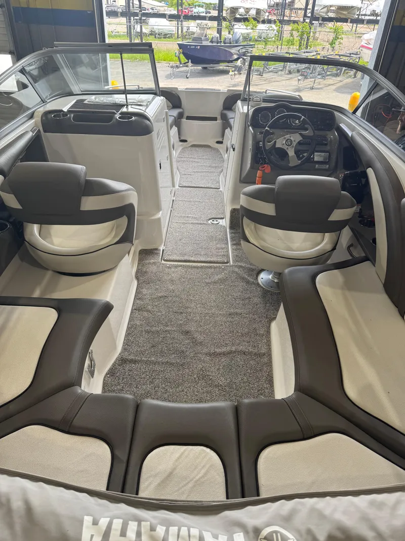 Slide: The Image of 2011 Yamaha Boats 242 Limited interior with seating and steering wheel. - 4