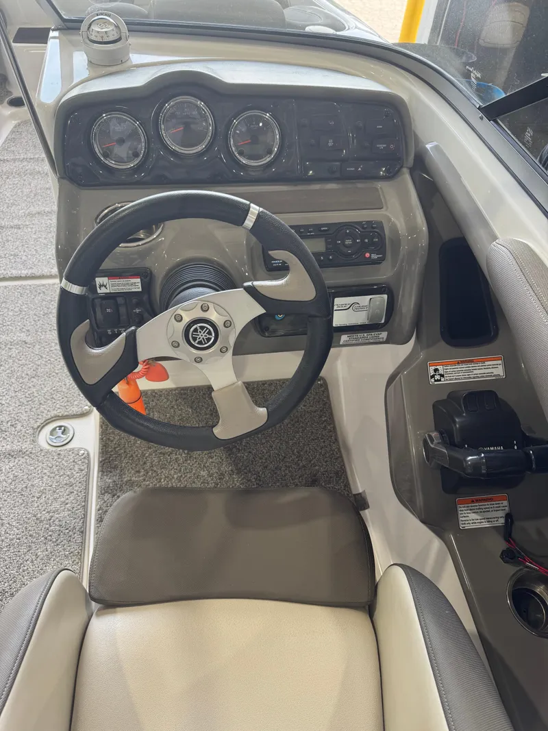 Slide: The Image of 2011 Yamaha Boats 242 Limited cockpit with steering wheel and instrument panel. - 5