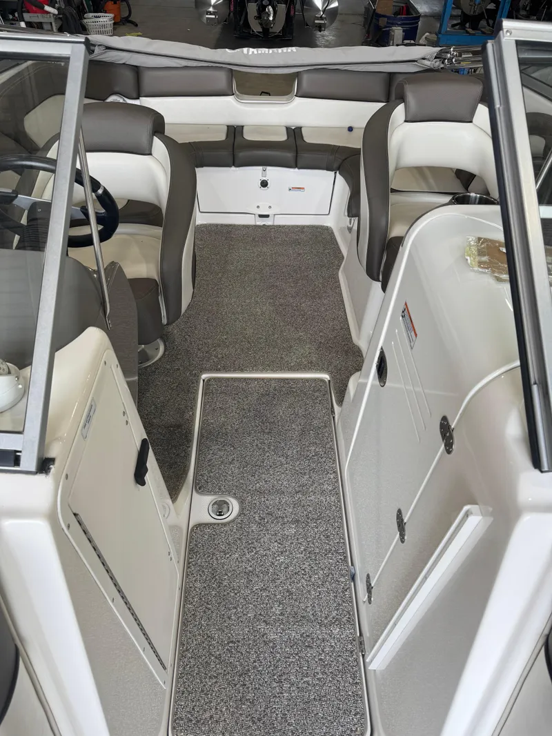 Slide: The Image of 2011 Yamaha Boats 242 Limited interior with gray seating and carpeted flooring. - 7