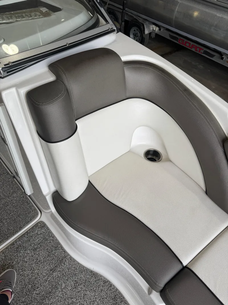 Slide: The Image of 2011 Yamaha Boats 242 Limited interior seating with gray and white upholstery. - 9