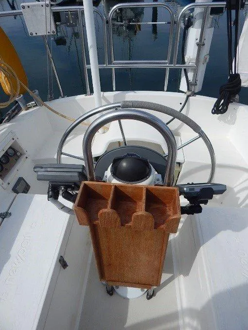 Slide: The Image of 1983 Newport 28 Sloop cockpit with steering wheel and wooden storage rack. - 15