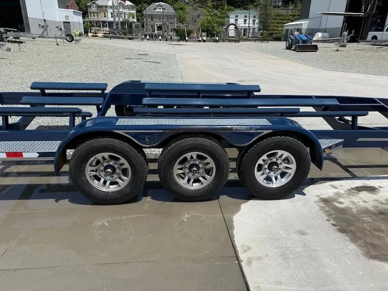 Slide: The Image of 2014 Cobalt boat trailer with triple axles in an industrial setting. - 4