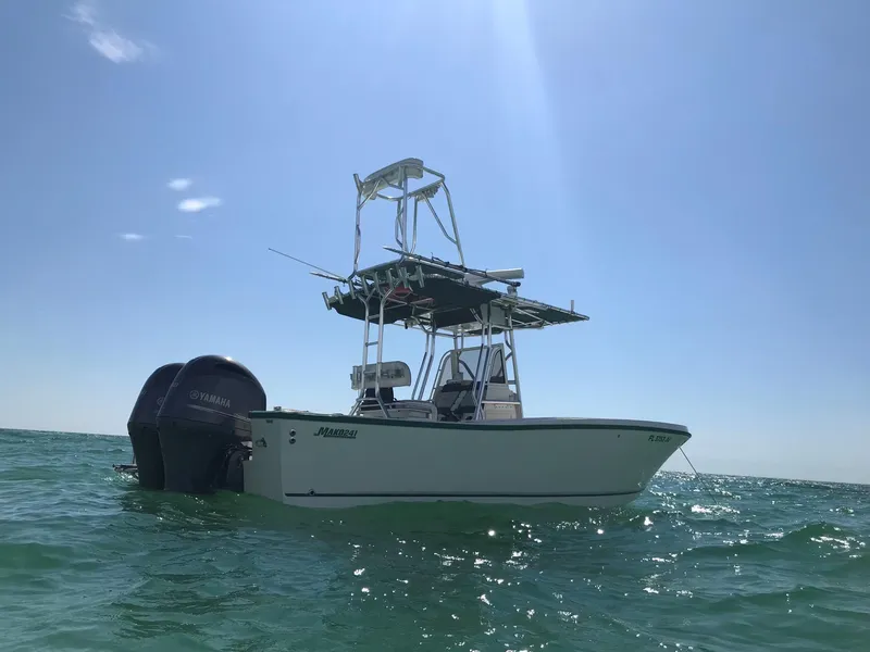 The Image of 1996 Mako 241 boat on open water under clear blue sky. - 1