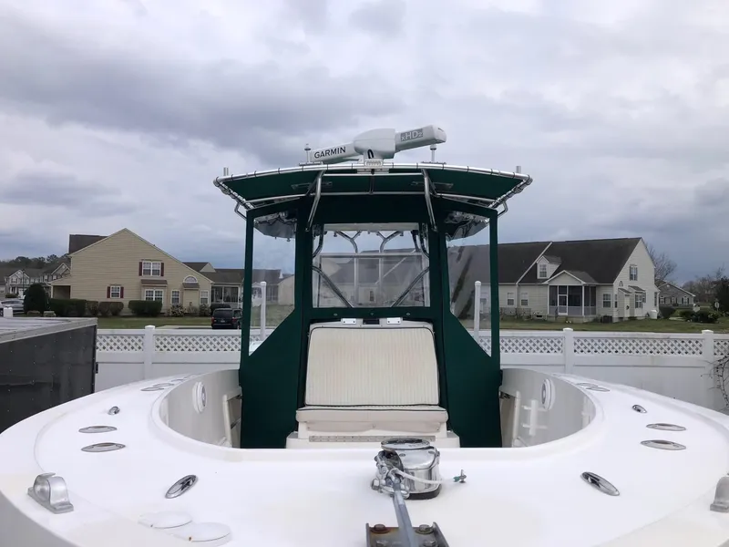 Slide: The Image of 1996 Mako 241 boat with green canopy, parked in residential area. - 3