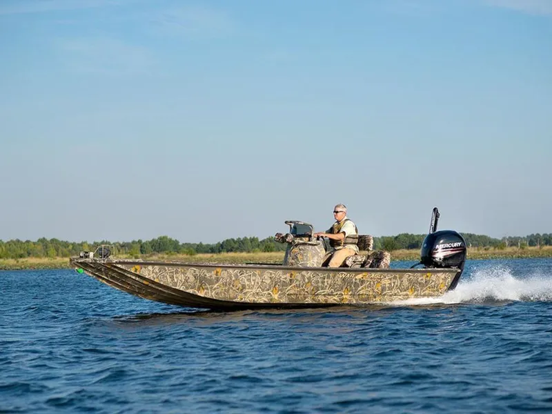 The Image of 2026 War Eagle Blackhawk 2170 boat cruising on a lake with a scenic background. - 0