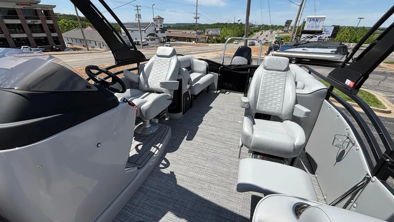 Slide: The Image of 2025 JC Neptoon 25TT Sport pontoon boat interior with modern seating and steering console. - 22