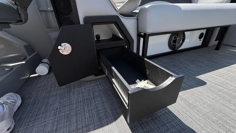 Slide: The Image of Open storage compartment in 2025 JC Neptoon 25TT Sport boat interior. - 26