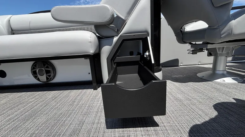Slide: The Image of 2025 JC Neptoon 25TT Sport boat interior with open storage drawer and seating. - 27