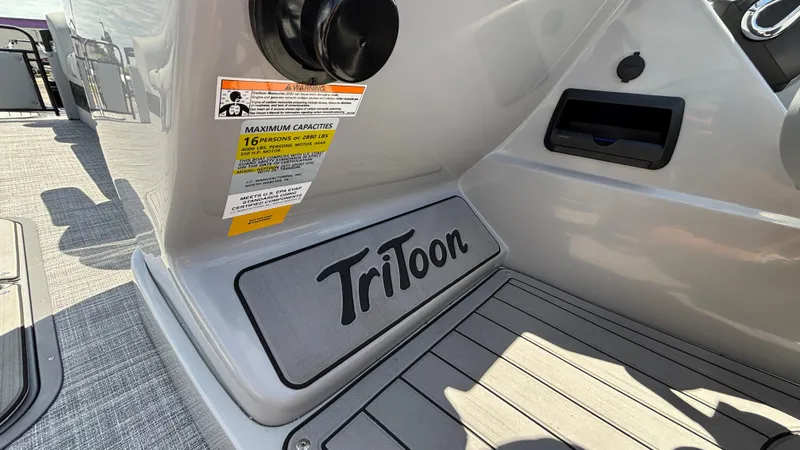 Slide: The Image of 2025 JC Neptoon 25TT Sport boat interior with Tritoon branding and capacity label. - 30