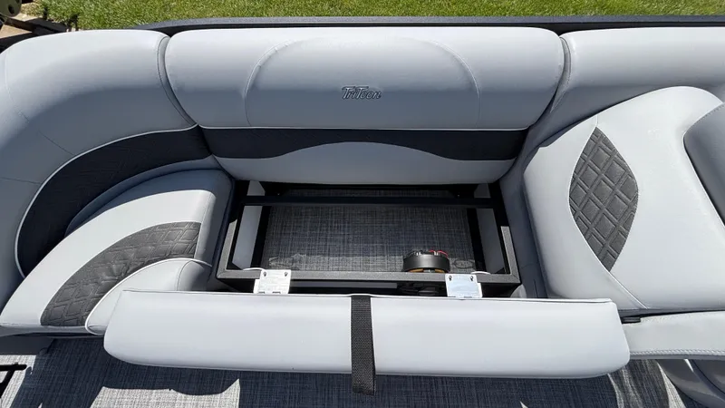 Slide: The Image of 2025 JC Neptoon 25TT Sport boat interior with gray seating and storage compartment. - 34