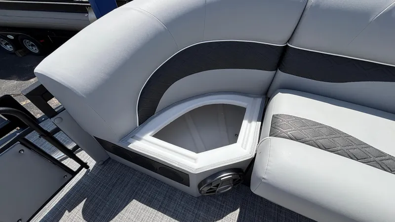 Slide: The Image of 2025 JC Neptoon 25TT Sport boat interior with open storage compartment and cushioned seating. - 35