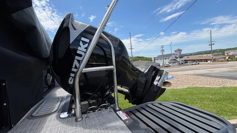 Slide: The Image of 2025 JC Neptoon 25TT Sport with Suzuki outboard motor, parked outdoors. - 4