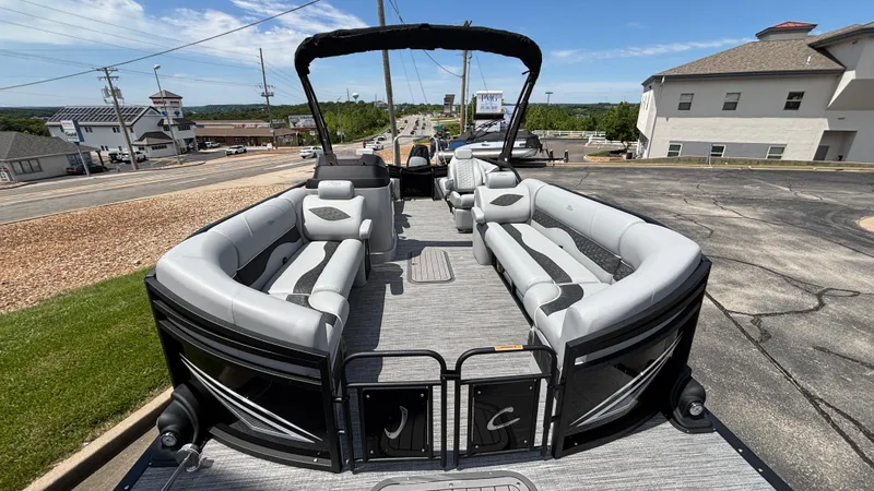 Slide: The Image of 2025 JC Neptoon 25TT Sport pontoon boat with spacious seating, parked on a sunny day. - 8