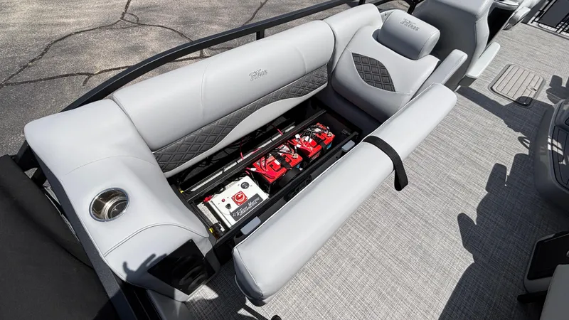 Slide: The Image of 2025 JC Neptoon 25TT Sport pontoon boat with open battery compartment and luxurious seating. - 10