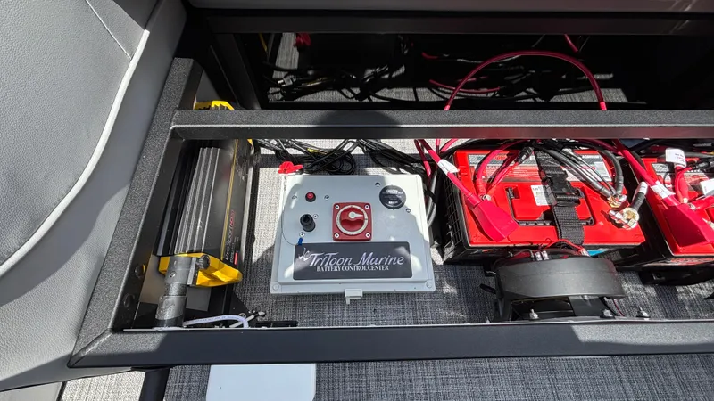 Slide: The Image of Electrical components and battery setup in a 2025 JC Neptoon 25TT Sport boat. - 11