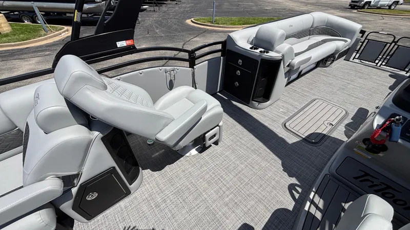 Slide: The Image of 2025 JC Neptoon 25TT Sport pontoon boat interior with gray seating and carpeted floor. - 15