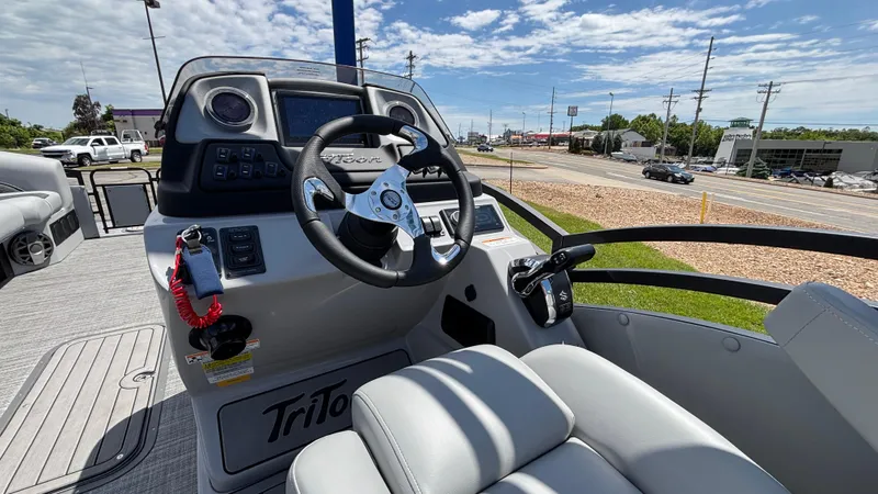 Slide: The Image of 2025 JC Neptoon 25TT Sport boat cockpit with steering wheel and controls. - 17
