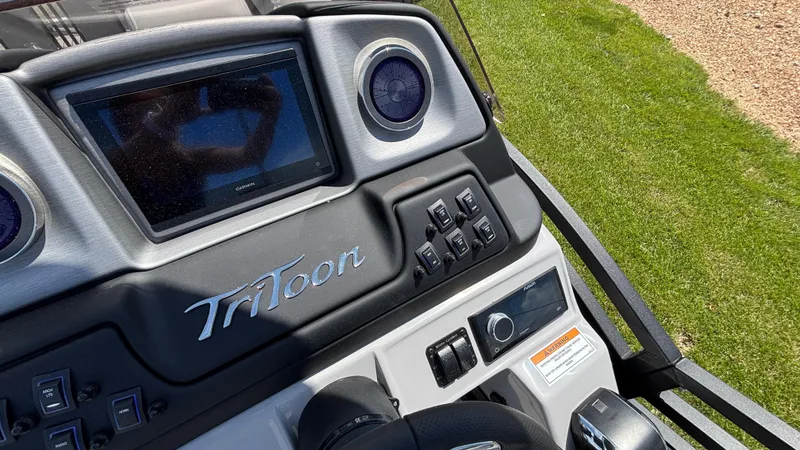Slide: The Image of Dashboard of 2025 JC Neptoon 25TT Sport boat with steering wheel and controls. - 19