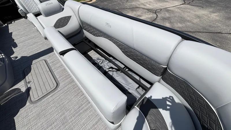 Slide: The Image of 2025 JC Neptoon 25TT Sport boat interior with gray seating and storage compartment. - 36