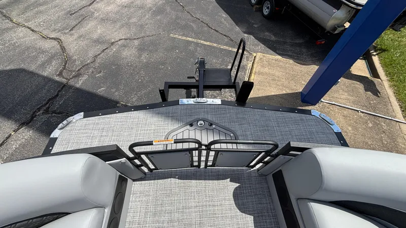 Slide: The Image of 2025 JC Neptoon 25TT Sport boat interior with gray seating and flooring. - 6