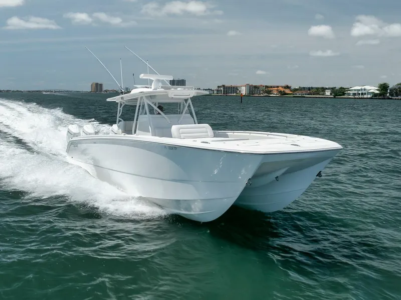 Slide: The Image of 2018 Invincible 40 Catamaran cruising on open water, showcasing sleek design and performance. - 12