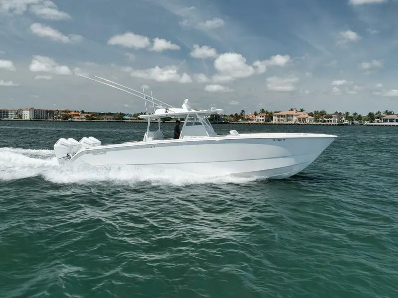 Slide: The Image of 2018 Invincible 40 Catamaran cruising on open water under a clear sky. - 13