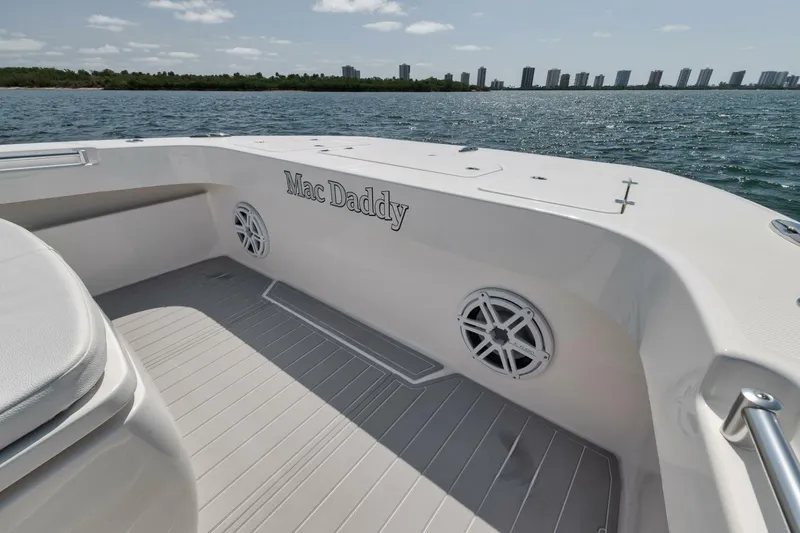 Slide: The Image of 2018 Invincible 40 Catamaran deck with "Mac Daddy" name, overlooking water and skyline. - 16