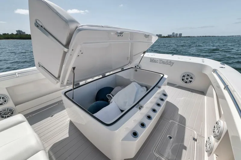 Slide: The Image of 2018 Invincible 40 Catamaran with open storage compartment on deck, ocean view. - 18
