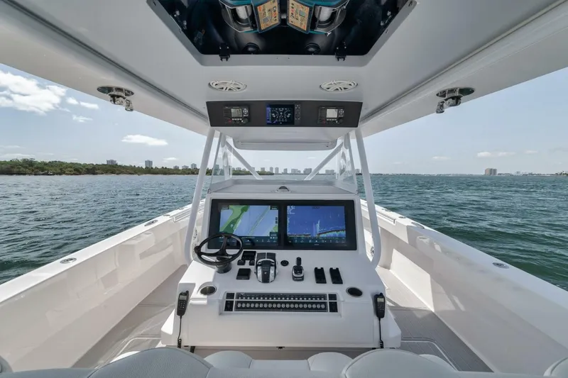 Slide: The Image of Invincible 40 Catamaran 2018 helm with dual screens on open water. - 26