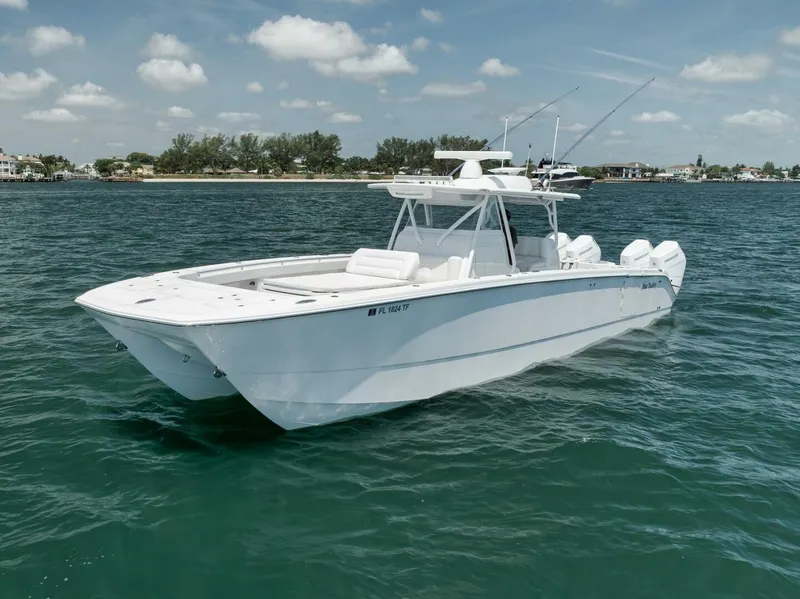 Slide: The Image of 2018 Invincible 40 Catamaran on calm water, clear sky, distant shoreline. - 3