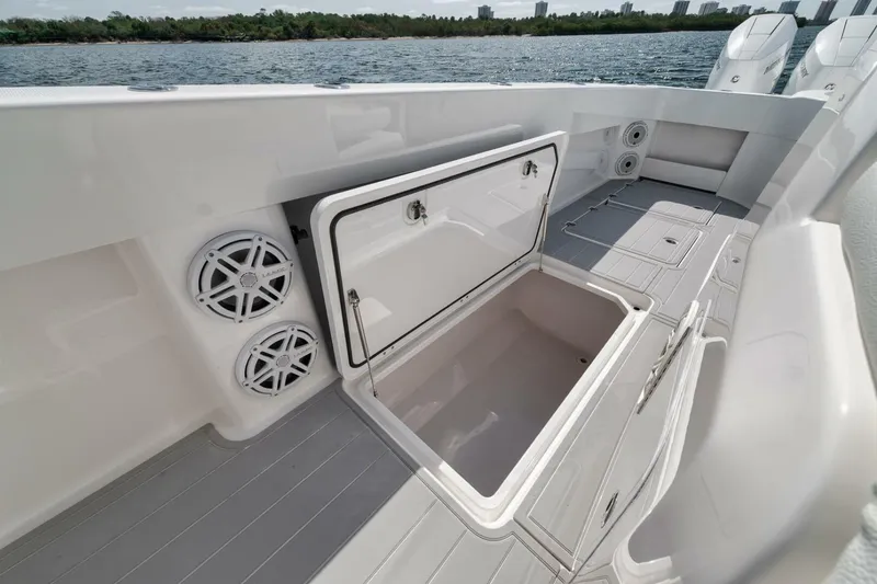 Slide: The Image of 2018 Invincible 40 Catamaran deck with open storage compartment and speakers. - 30
