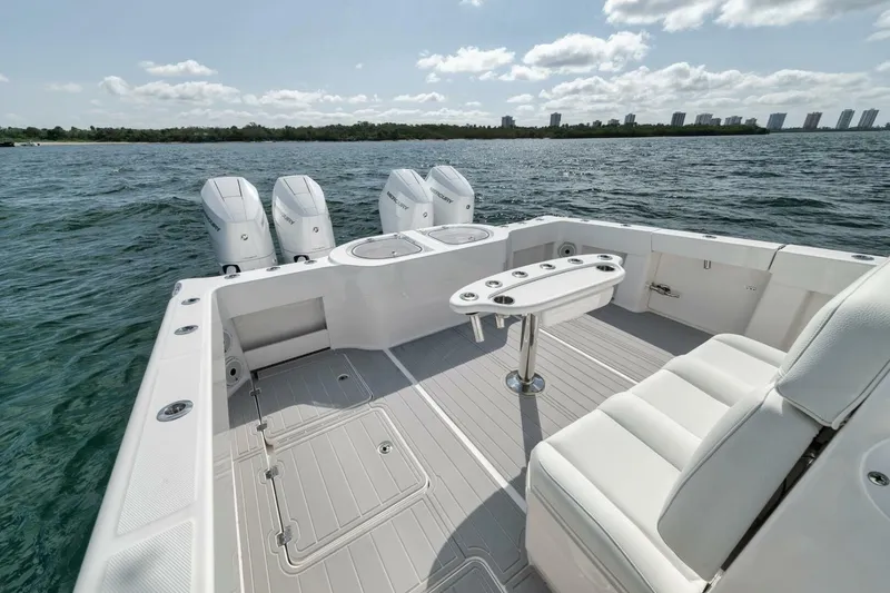 Slide: The Image of 2018 Invincible 40 Catamaran with quad engines, spacious deck, and seating on open water. - 31