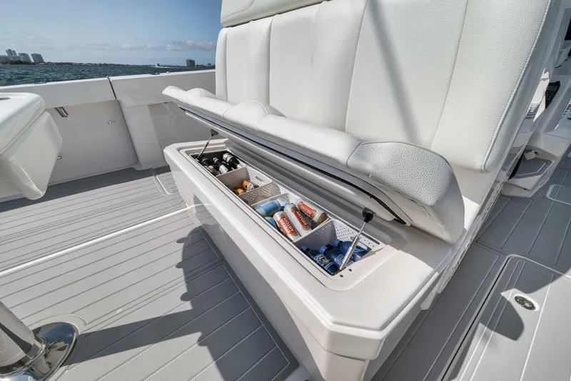 Slide: The Image of 2018 Invincible 40 Catamaran with open storage compartment, stocked with beverages, on a sunny day. - 32