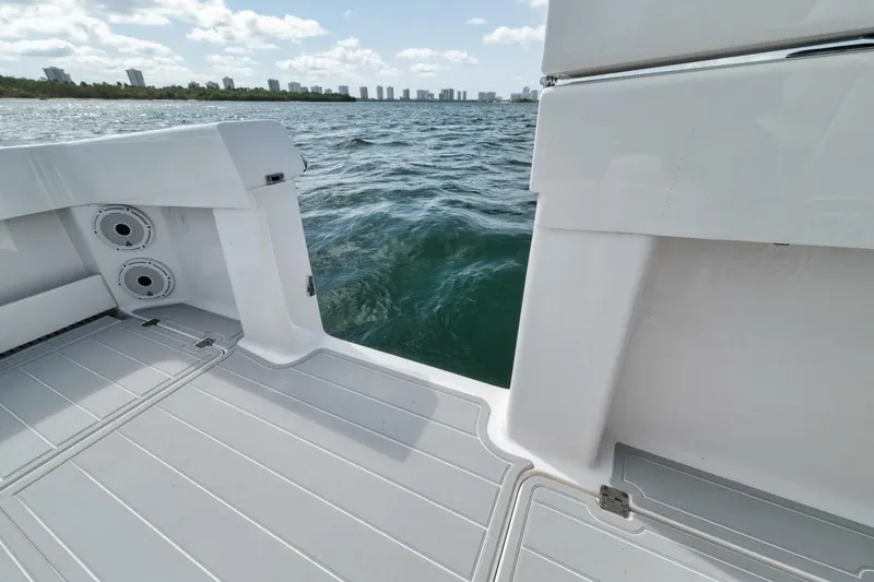Slide: The Image of 2018 Invincible 40 Catamaran deck view with ocean backdrop and city skyline. - 35