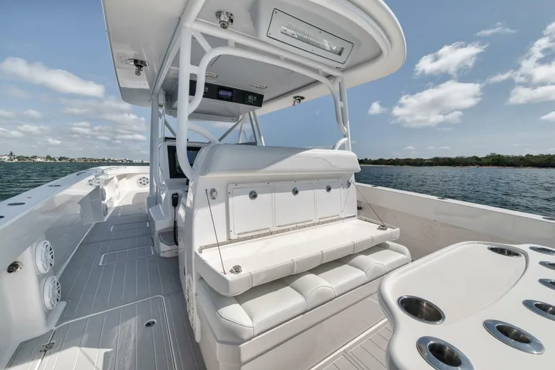 Slide: The Image of 2018 Invincible 40 Catamaran interior with seating and rod holders on a sunny day. - 36
