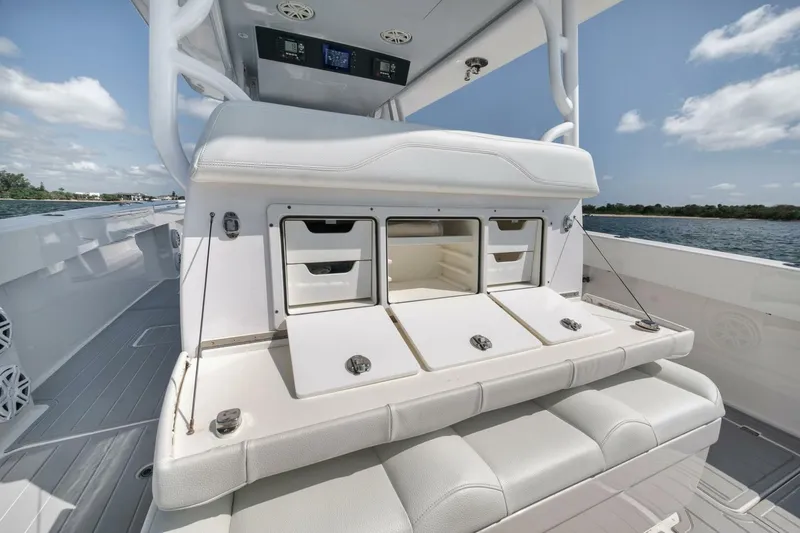 Slide: The Image of Invincible 40 Catamaran 2018 interior with storage compartments and seating, on a sunny day. - 37
