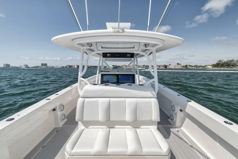 Slide: The Image of Invincible 40 Catamaran 2018 on open water, featuring sleek white seating and modern helm. - 39