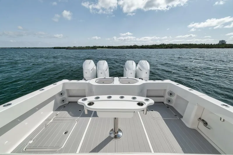 Slide: The Image of Invincible 40 Catamaran 2018, spacious deck with quad engines, on open water. - 40