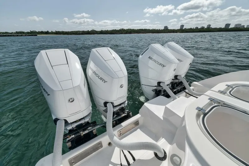 Slide: The Image of Four Mercury outboard engines on a 2018 Invincible 40 Catamaran, cruising on open water. - 46