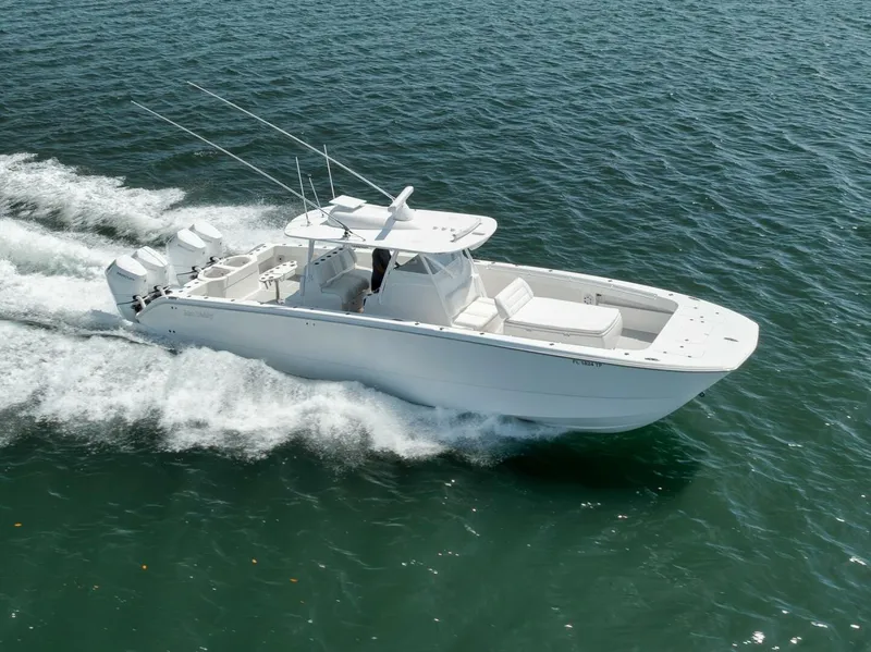 Slide: The Image of 2018 Invincible 40 Catamaran cruising on open water, showcasing sleek design and powerful engines. - 47