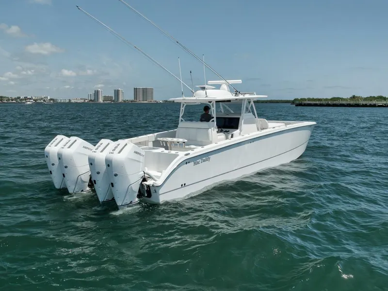 Slide: The Image of 2018 Invincible 40 Catamaran on open water with triple outboard engines. - 7