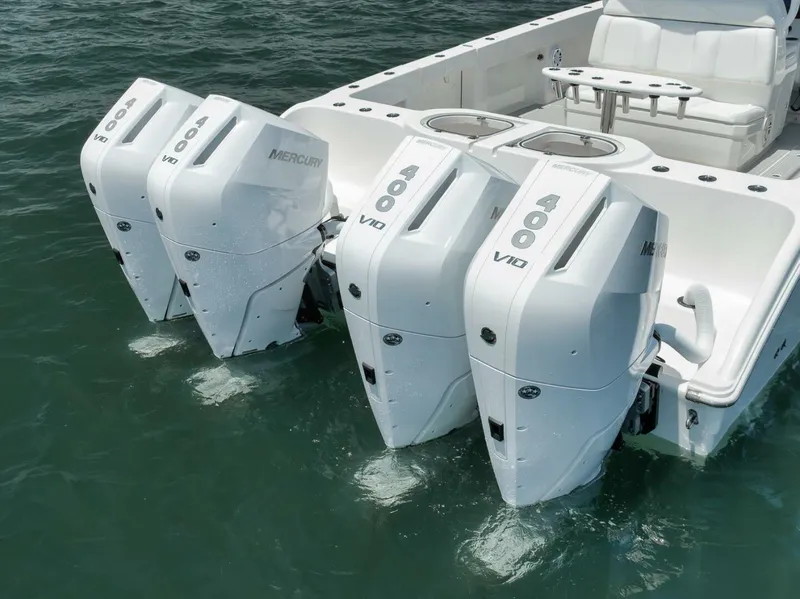 Slide: The Image of Four Mercury outboard engines on a 2018 Invincible 40 Catamaran in the water. - 8