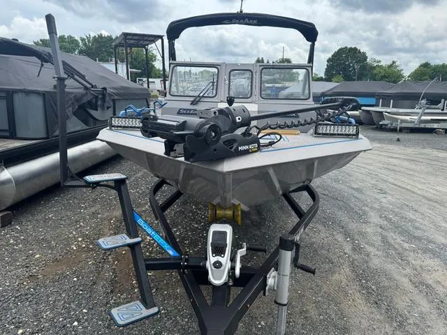 Slide: The Image of 2023 SeaArk Pro Cat 240 boat with advanced trolling motor, parked on gravel lot. - 10