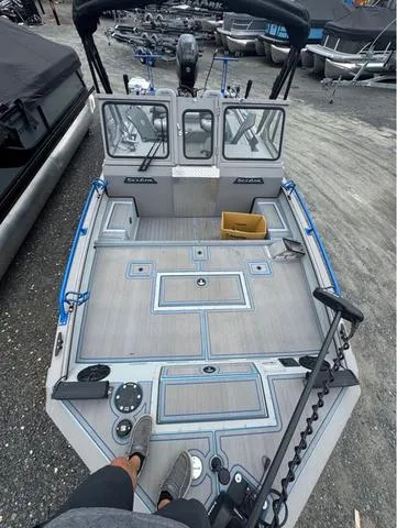 Slide: The Image of 2023 SeaArk Pro Cat 240 boat with spacious deck and modern features. - 11