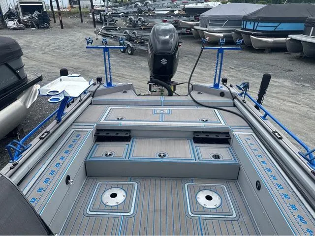 Slide: The Image of 2023 SeaArk Pro Cat 240 boat with fishing rod holders and Suzuki outboard motor. - 2