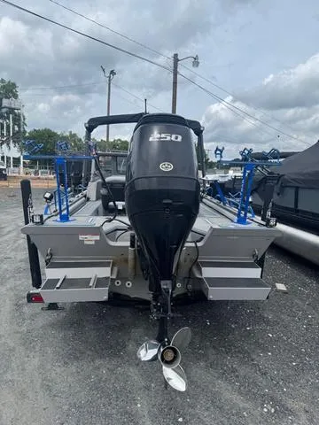 Slide: The Image of 2023 SeaArk Pro Cat 240 boat with powerful outboard motor, parked on gravel. - 3