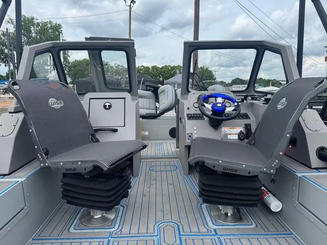 Slide: The Image of 2023 SeaArk Pro Cat 240 boat interior with dual Wise seats and steering console. - 4