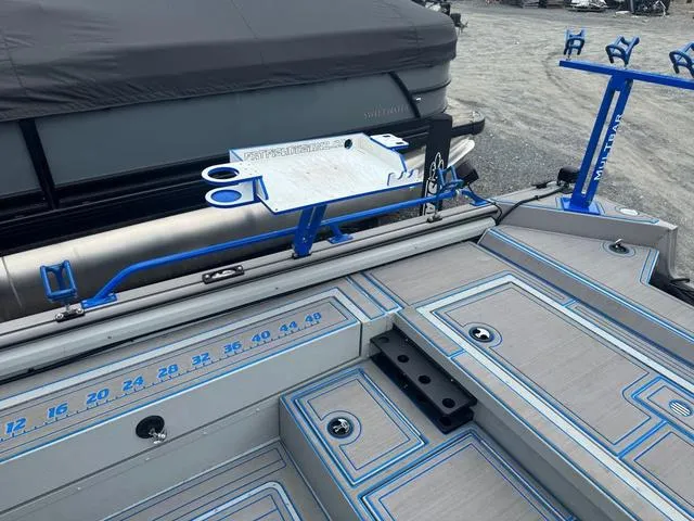 Slide: The Image of 2023 SeaArk Pro Cat 240 boat deck with blue accents and measurement markings. - 7