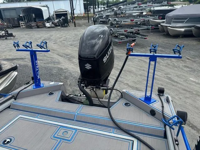 Slide: The Image of 2023 SeaArk Pro Cat 240 boat with Suzuki outboard motor and rod holders. - 8